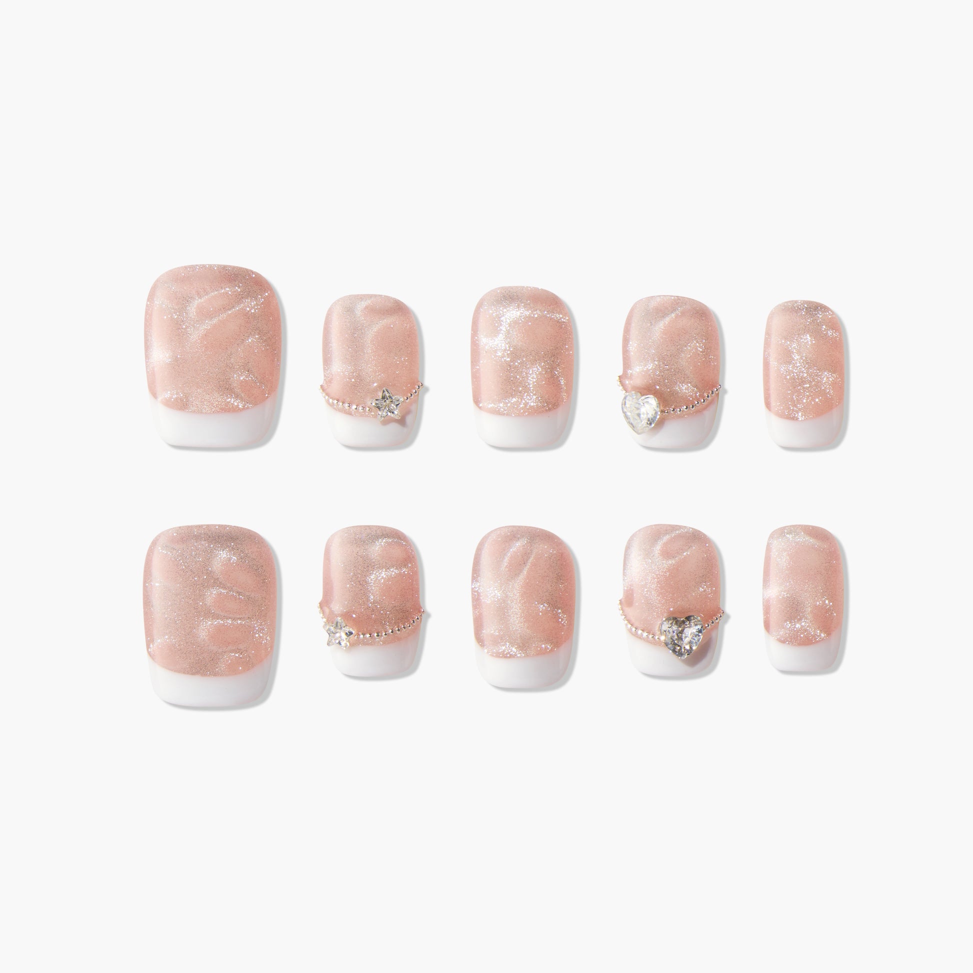 Set of pink glitter press-on nails with white tips and gemstone accents, displayed on white background.