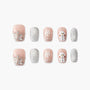 Handmade press-on nails with pink and silver glitter, snowflakes, gem accents, and snowman design