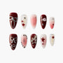 Red and pink press-on nails with star, bow, pearl, and 3D embellishments, arranged on white background