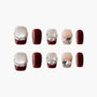 Handmade press-on nails in burgundy, glitter, and nude with pearl and gem accents, stylish set