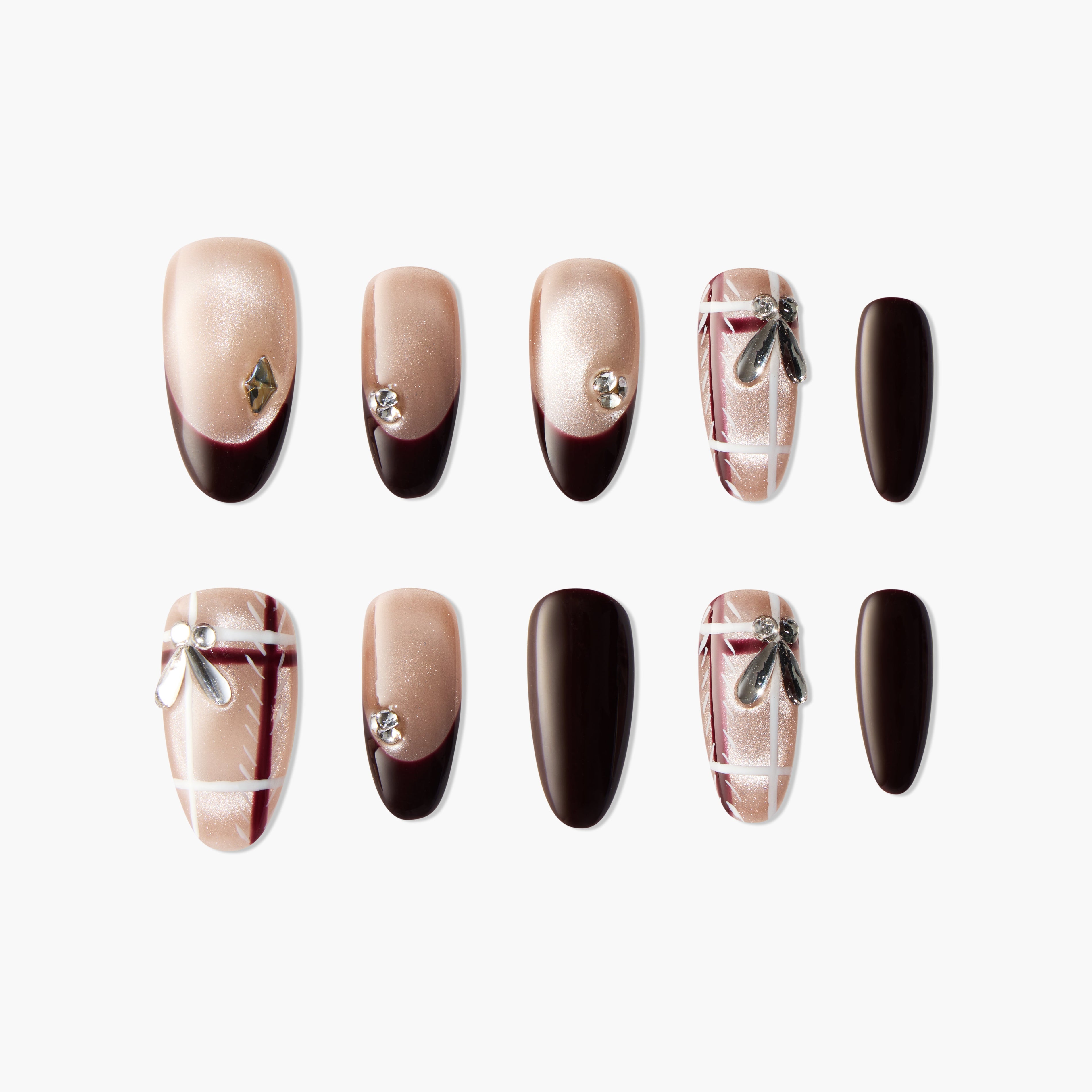 Handmade press-on nails in nude and dark brown with rhinestones, bows, and plaid accents.