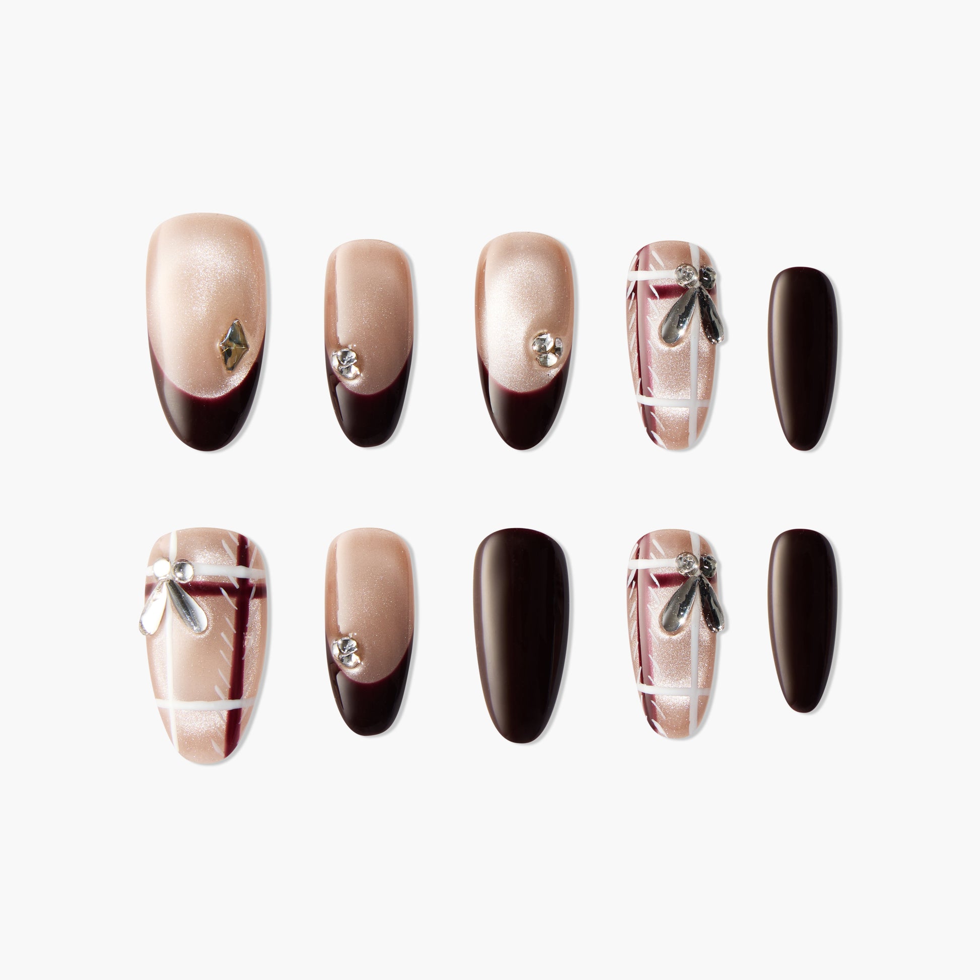 Handmade press-on nails in nude and dark brown with rhinestones, bows, and plaid accents.