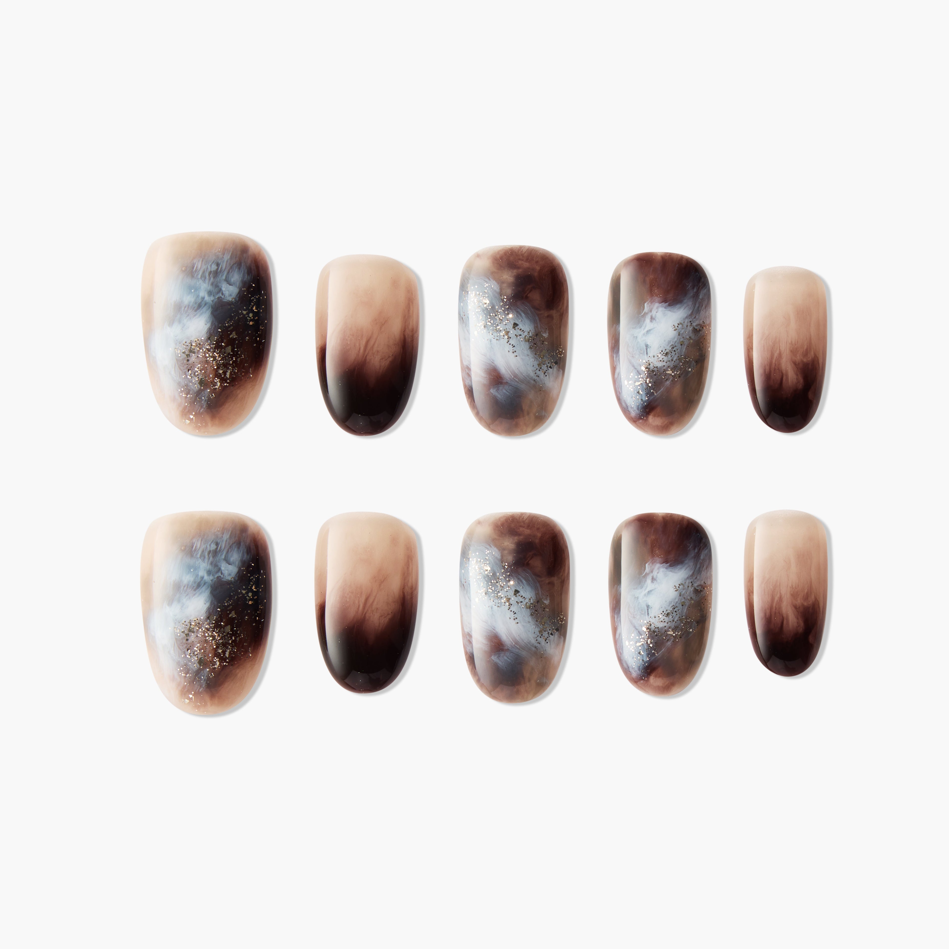 Handmade press-on nails with brown, nude, and blue marble design and subtle glitter accents