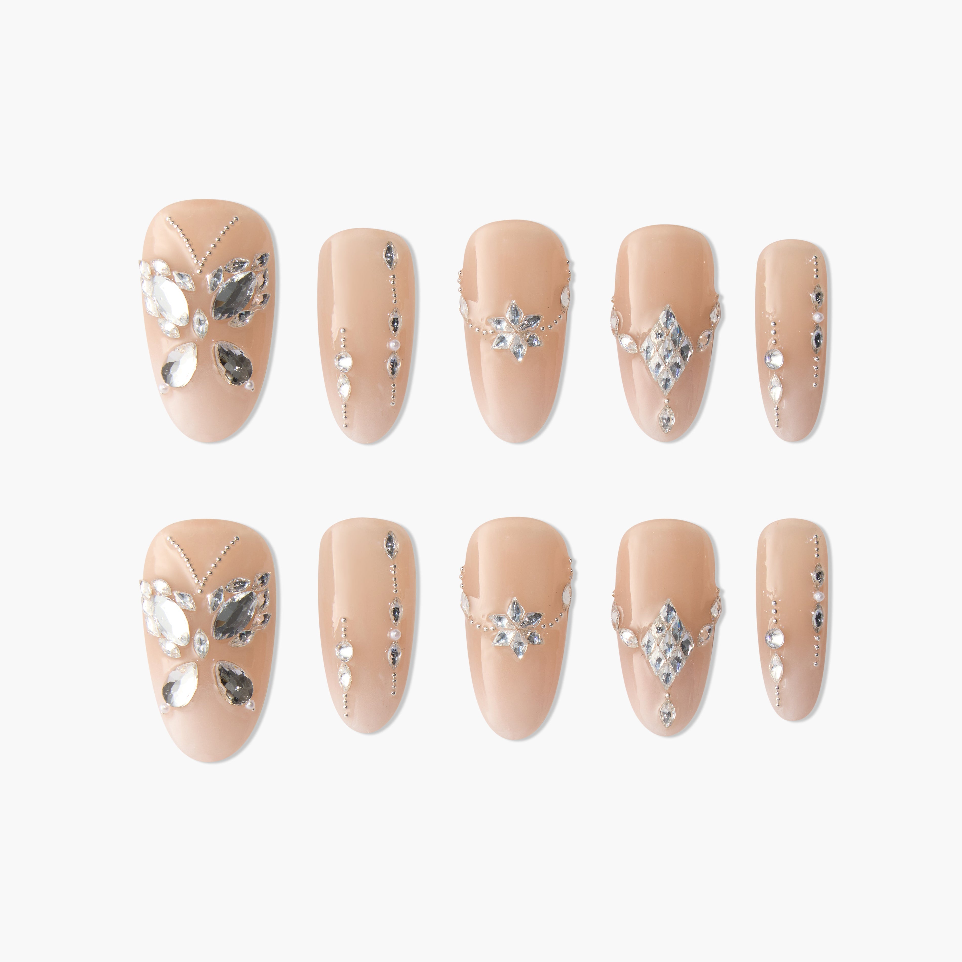 Nude press-on nails with silver rhinestone butterfly and geometric designs