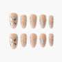 Nude press-on nails with silver rhinestone butterfly and geometric designs