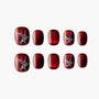 Red press-on nails set featuring glitter starfish designs and glossy finish on a white background.