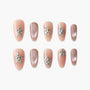 Handmade press-on nails in nude and glitter pink with rhinestone star accents, elegant design