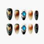 Handmade press-on nails with floral art, gemstone accents, and gradient brown designs