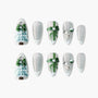 Handmade press-on nails with glitter, Christmas tree, green bows, and festive accents