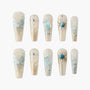 Handmade press-on nails with 3D blue butterfly, pearl, gemstone, and gold foil accents