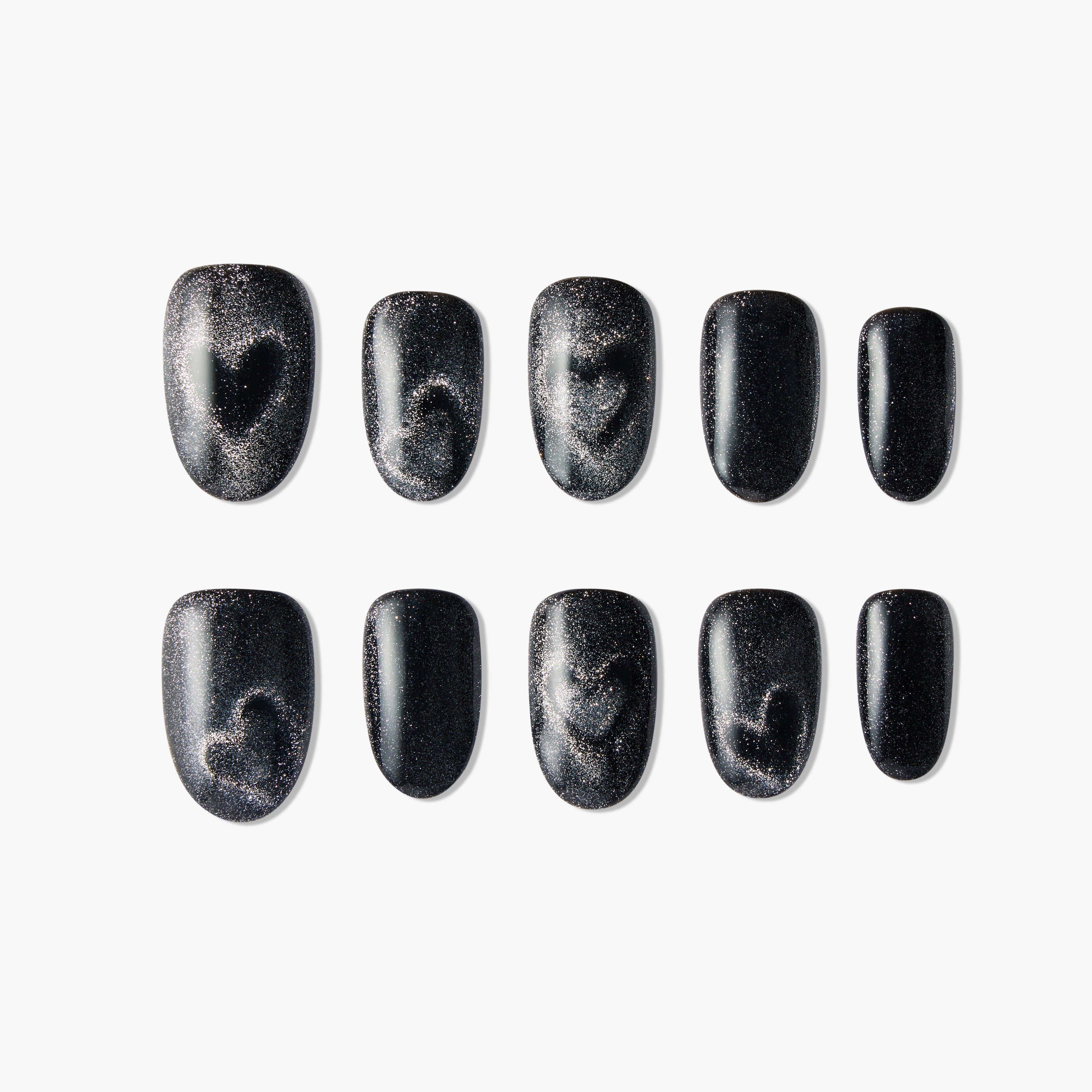 Black press-on nails with silver glitter and heart design, arranged on a white background.