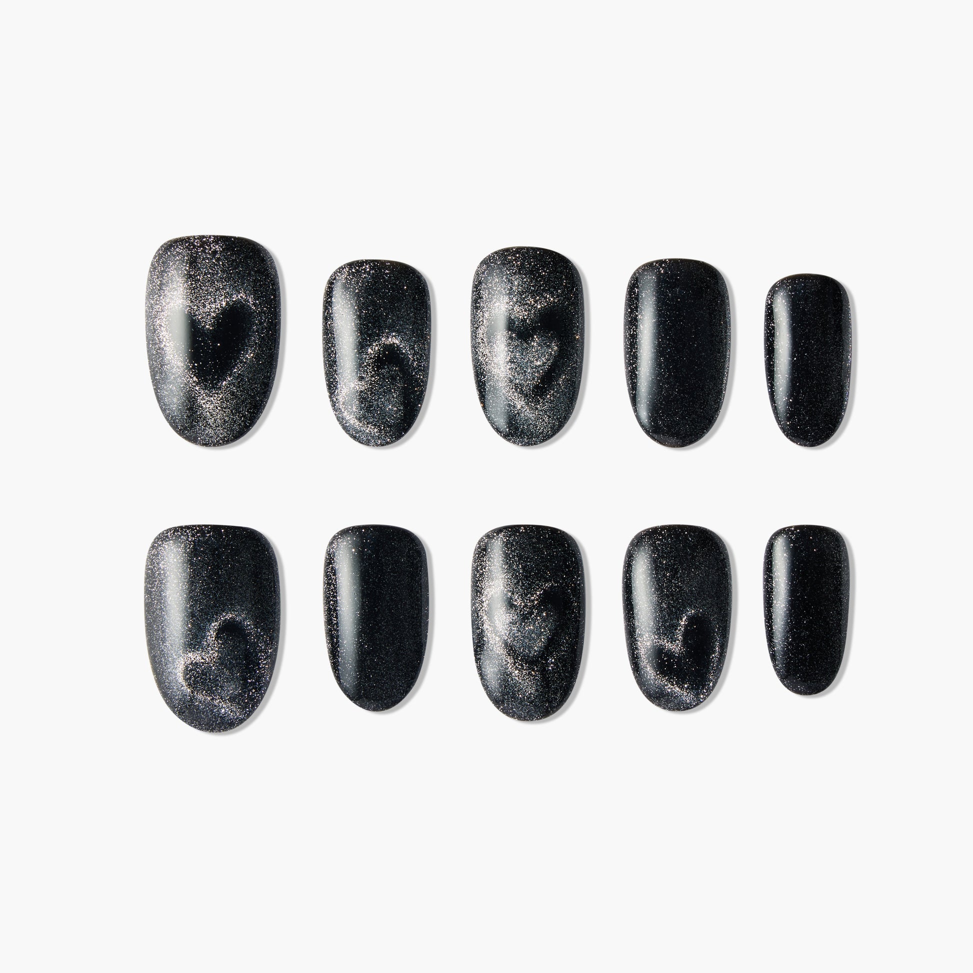 Black press-on nails with silver glitter and heart design, arranged on a white background.
