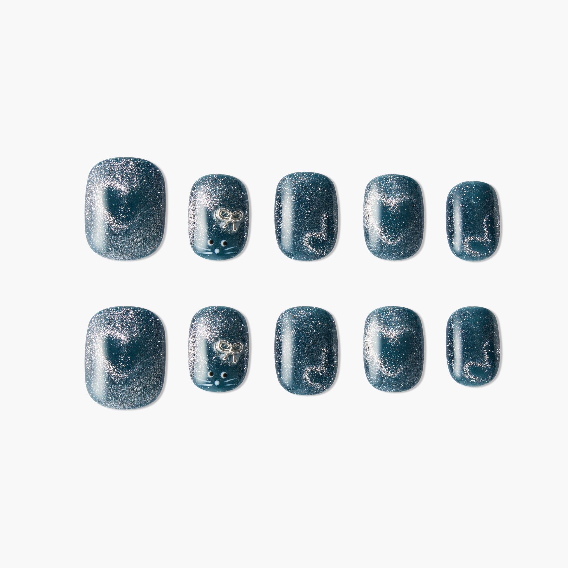 Glittery blue handmade press-on nails with silver heart, bow, and dot accents, set of ten