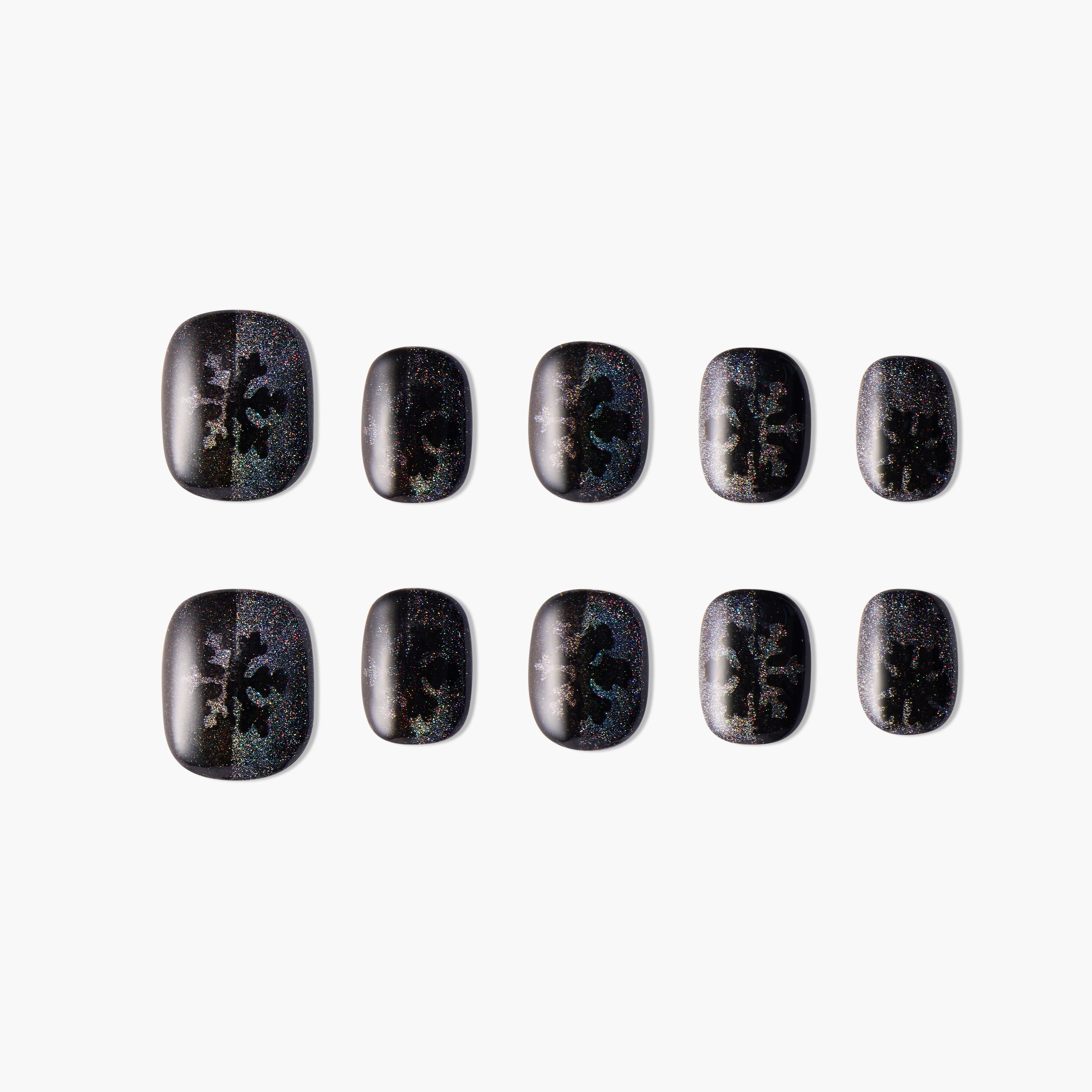 Black press-on nails with holographic glitter and abstract patterns, set of ten on white background