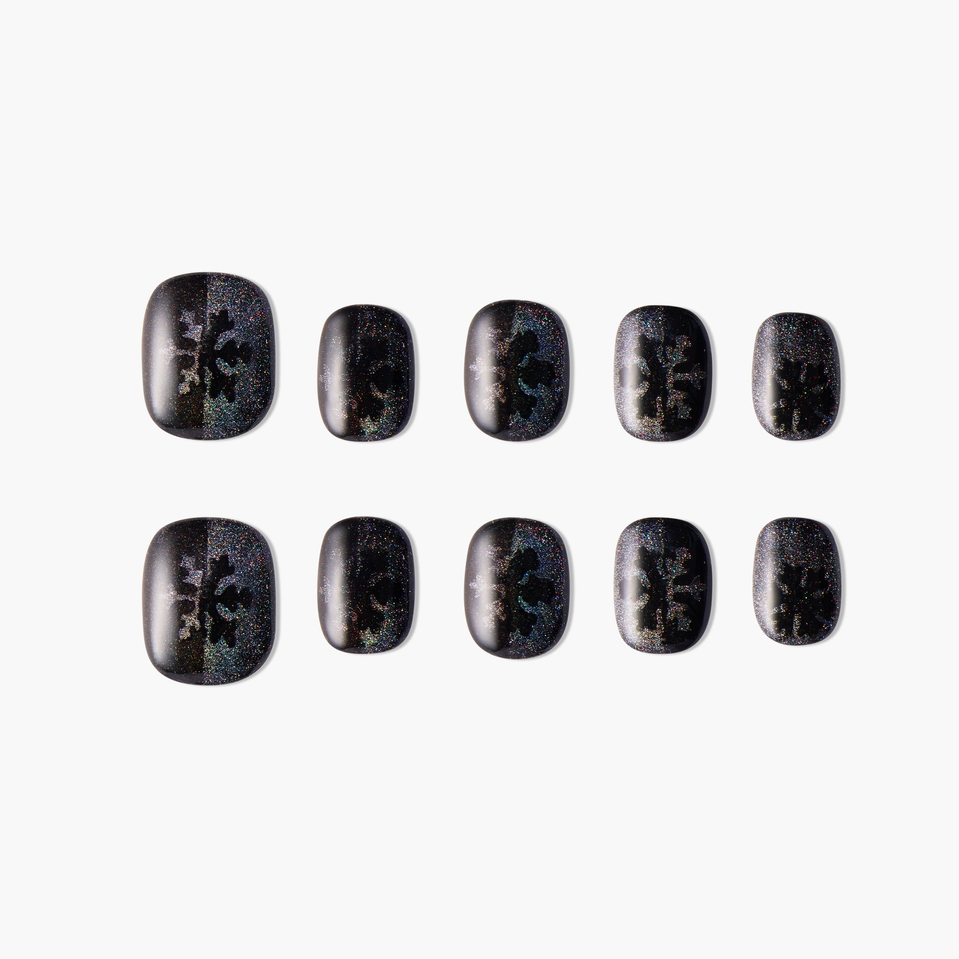 Black press-on nails with holographic glitter and abstract patterns, set of ten on white background