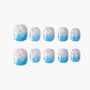 Set of square press-on nails with blue and silver glitter ombre design on white background