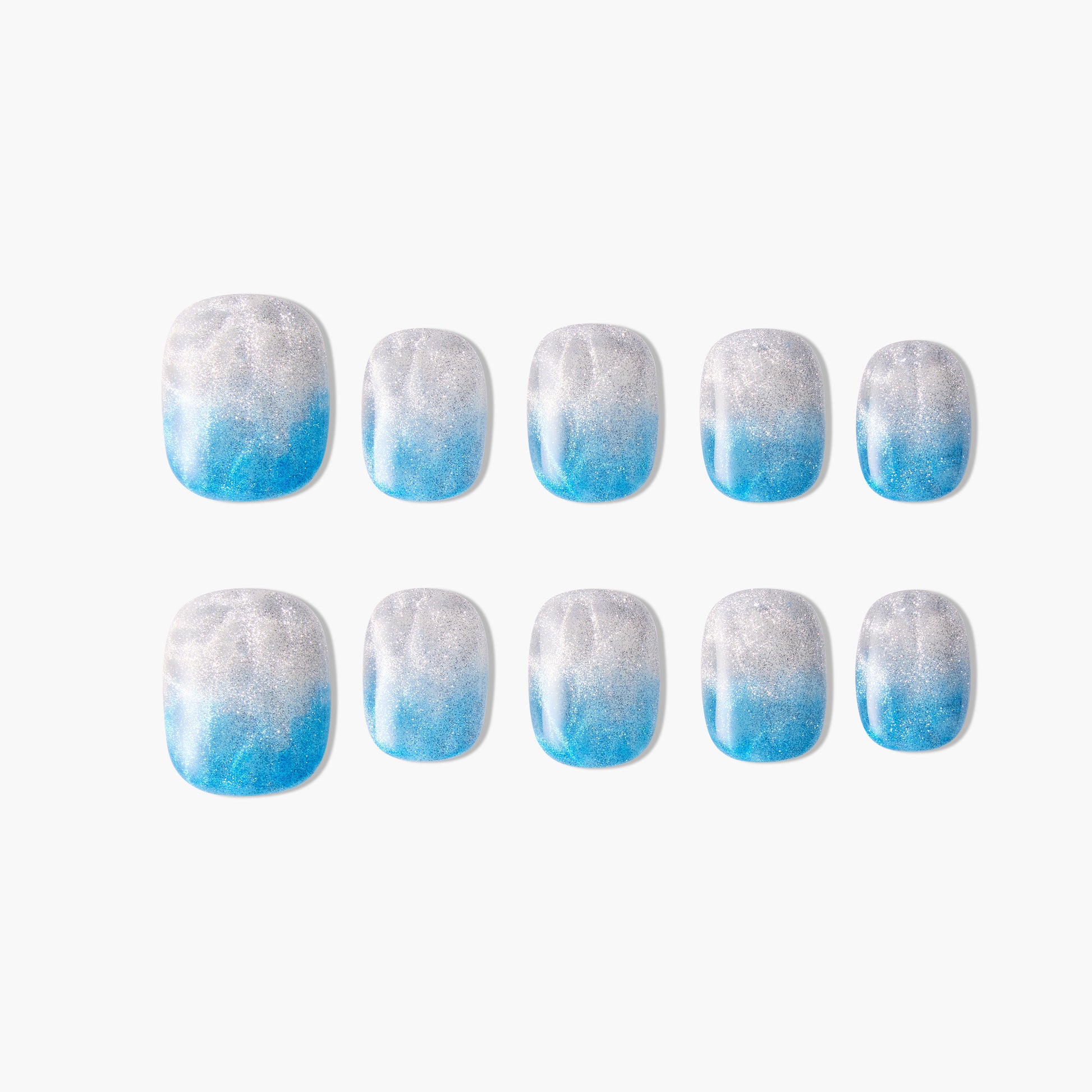 Set of square press-on nails with blue and silver glitter ombre design on white background