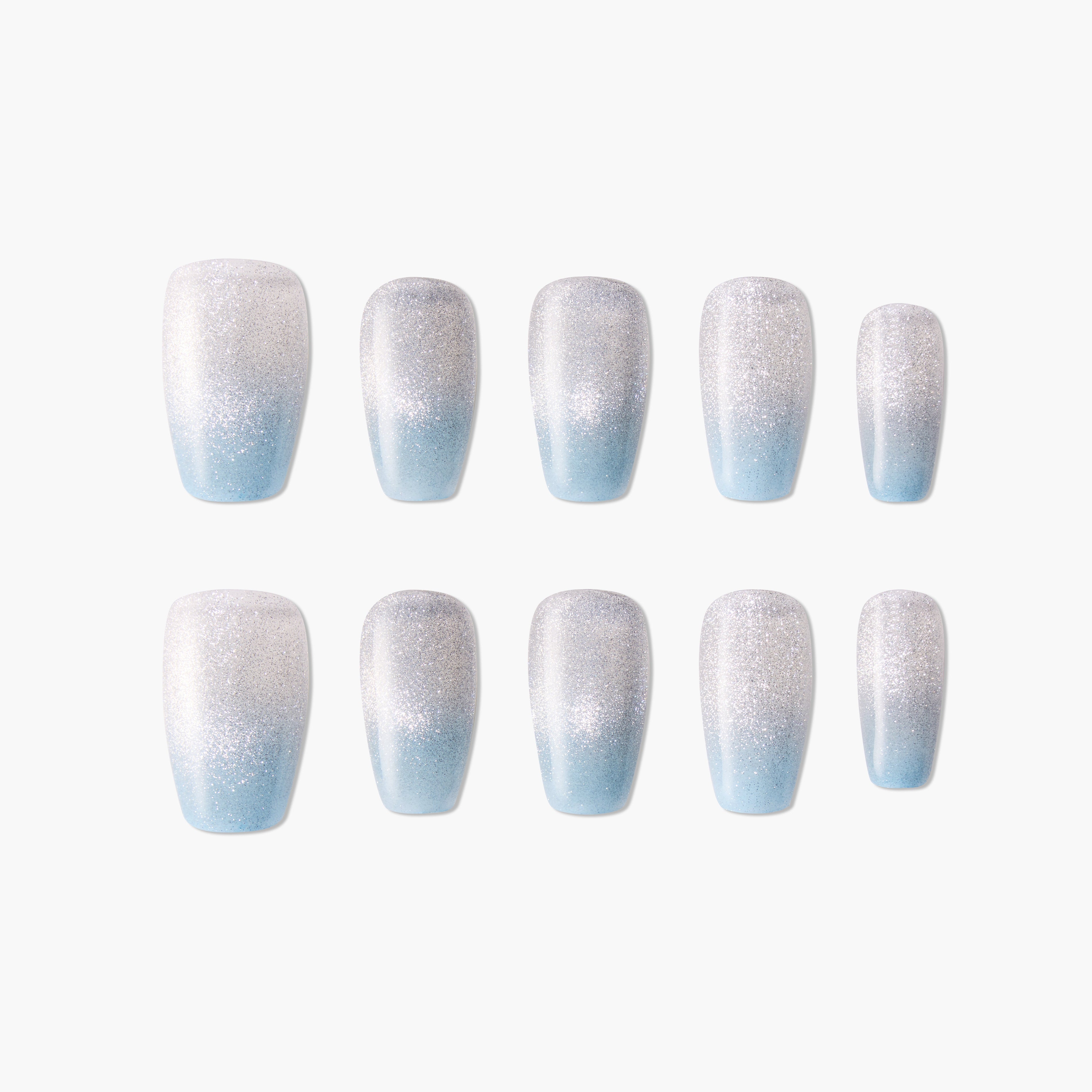 Set of press-on nails with silver glitter and blue ombre design on white background