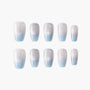 Set of press-on nails with silver glitter and blue ombre design on white background