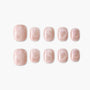 Set of pink glitter press-on nails with heart design, short square shape, on white background.