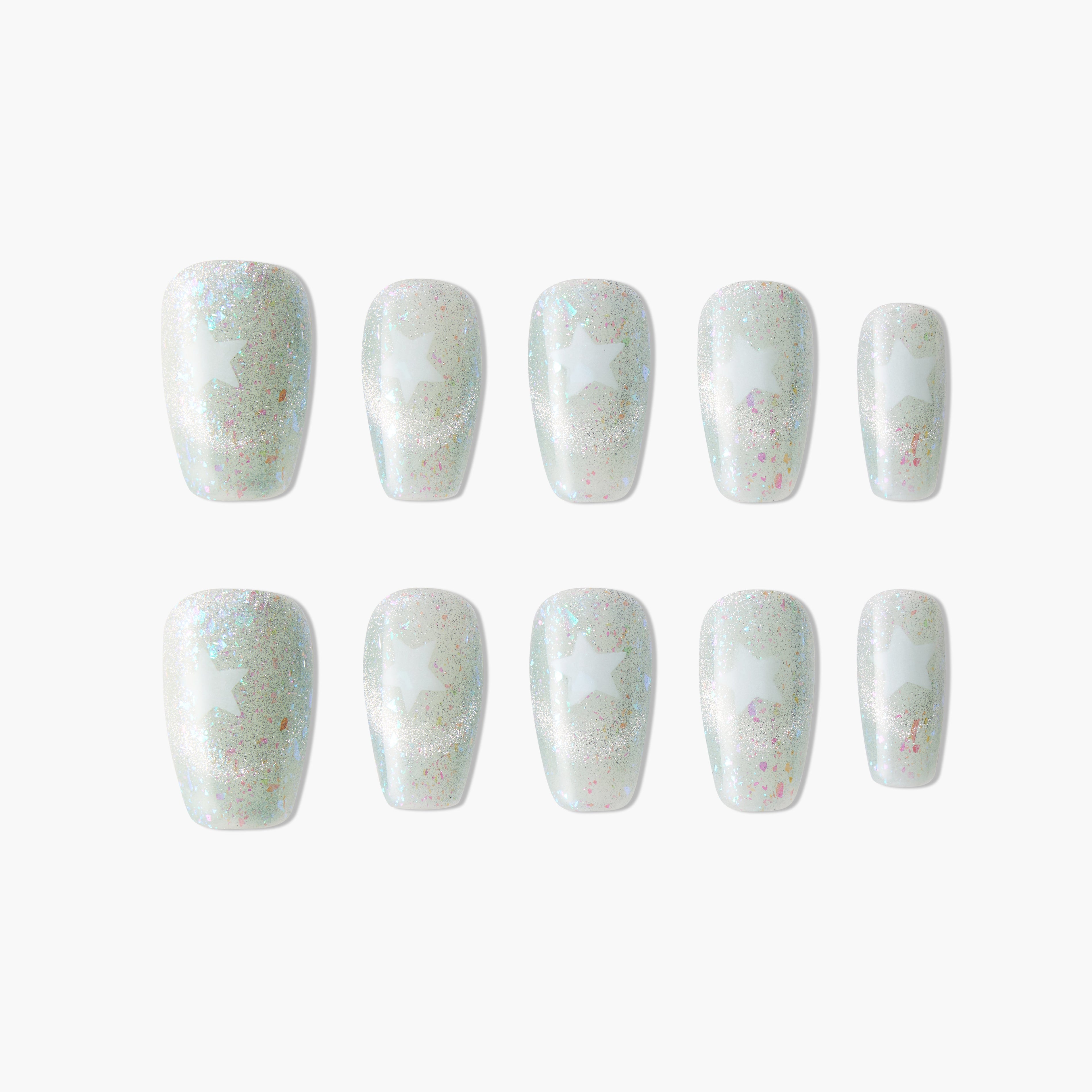 Iridescent press-on nails with white star design and glitter, arranged on white background