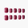 Set of glossy glitter dark red press-on nails displayed on white background