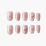 Pink glitter press-on nails with heart design, arranged on a white background