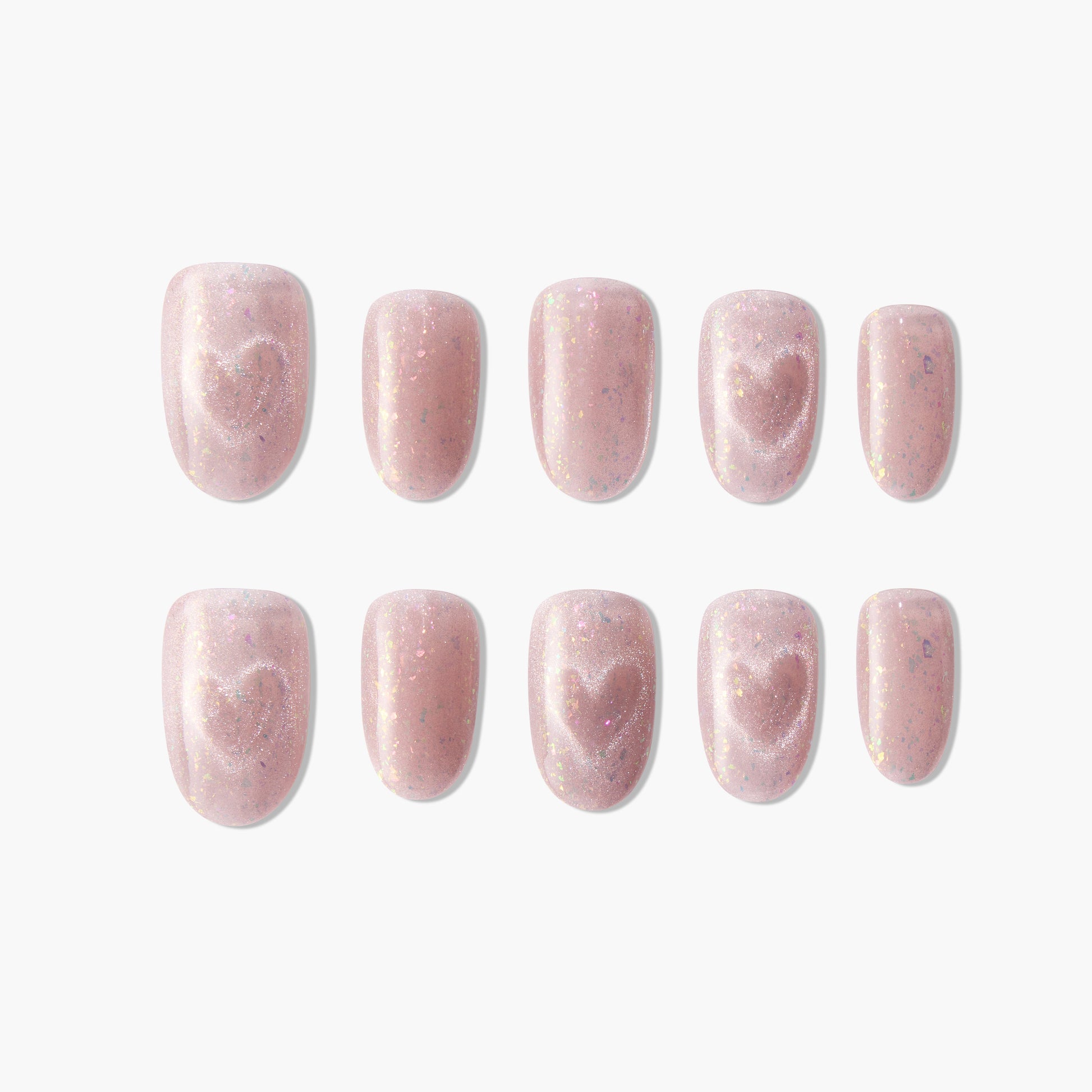 Pink glitter press-on nails with heart design, arranged on a white background