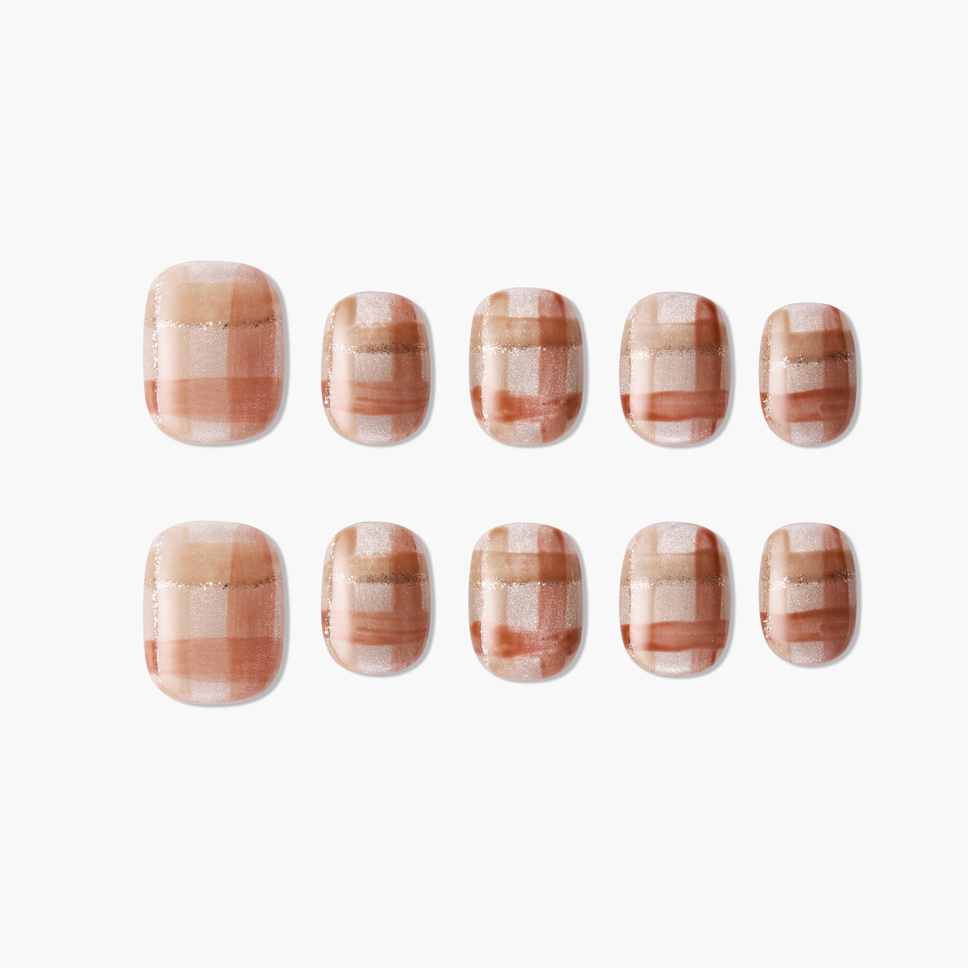 Set of handmade press-on nails with a brown and nude plaid design and glitter accents