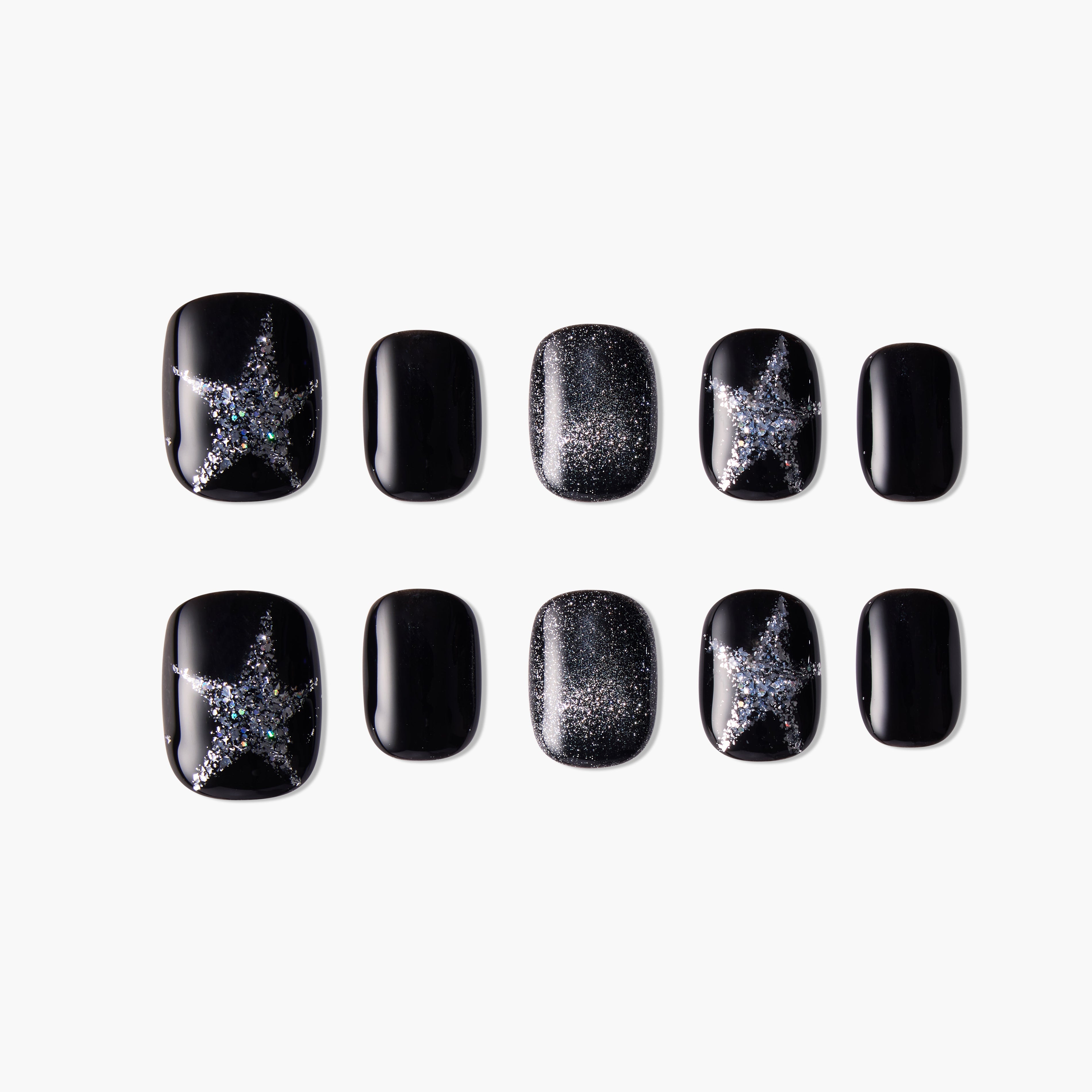 Black press-on nails with silver glitter star and shimmer designs, arranged on white background
