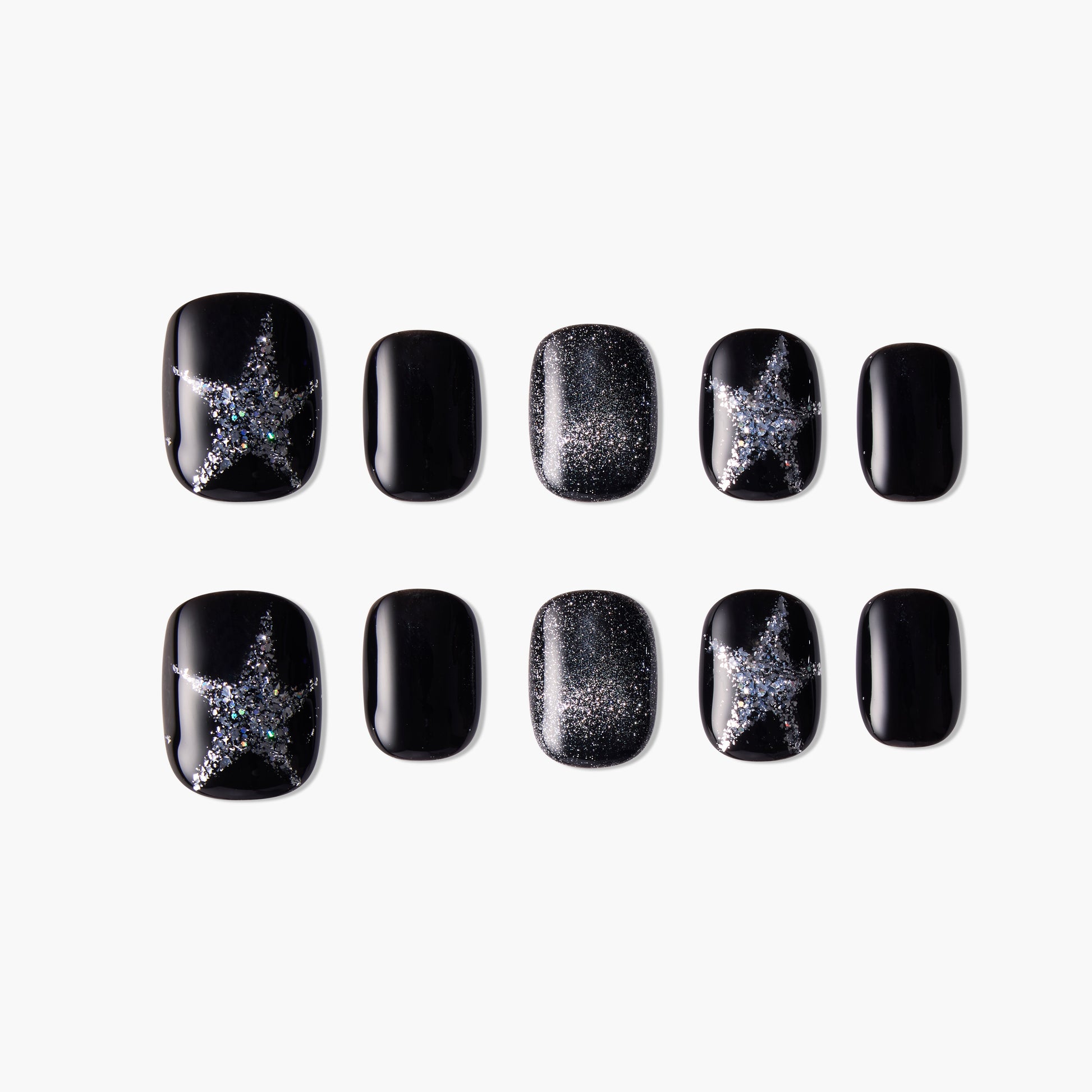 Black press-on nails with silver glitter star and shimmer designs, arranged on white background