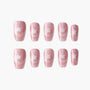 Pink glitter press-on nails with white star design, arranged on a white background.