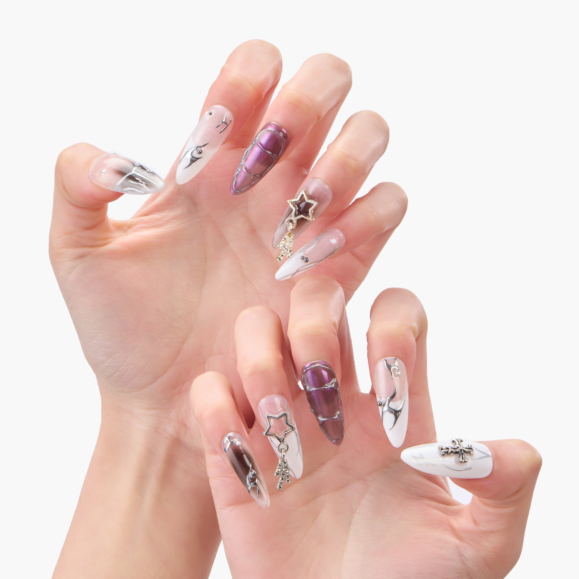 Handmade press-on nails featuring long almond shape, purple chrome, marble accents, and star charms