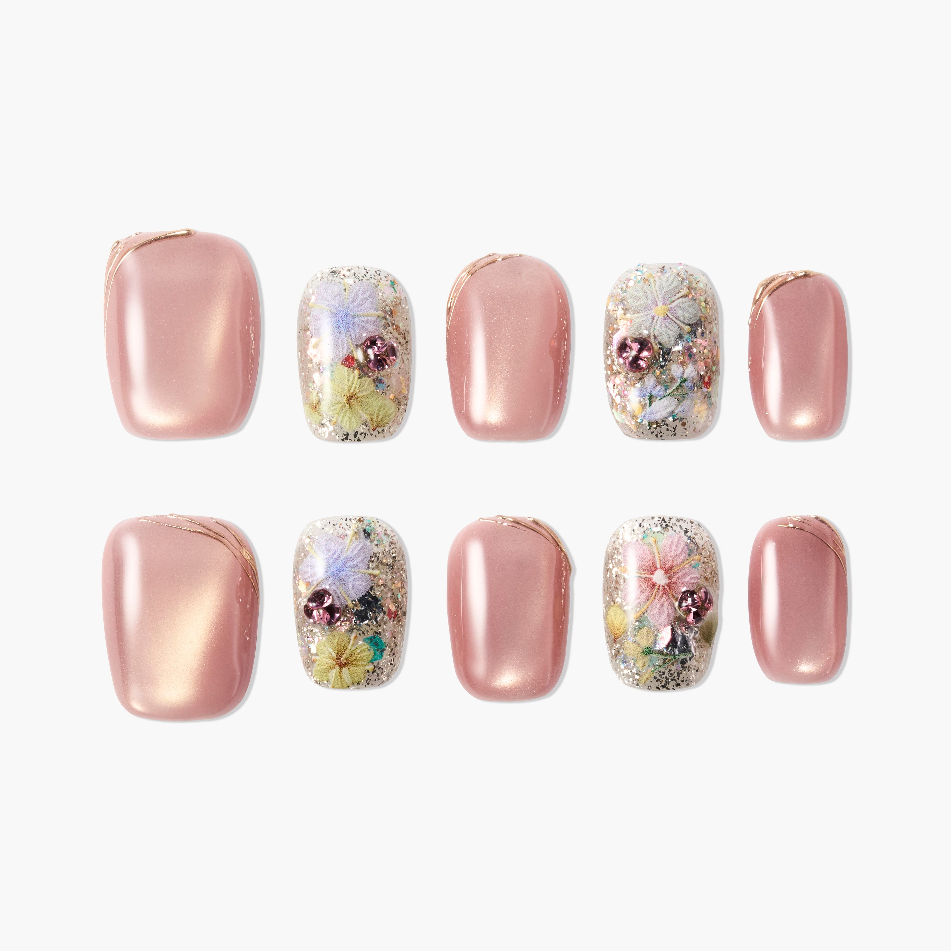 Handmade press-on nails with pink shimmer, glitter, and floral designs, arranged on white background.