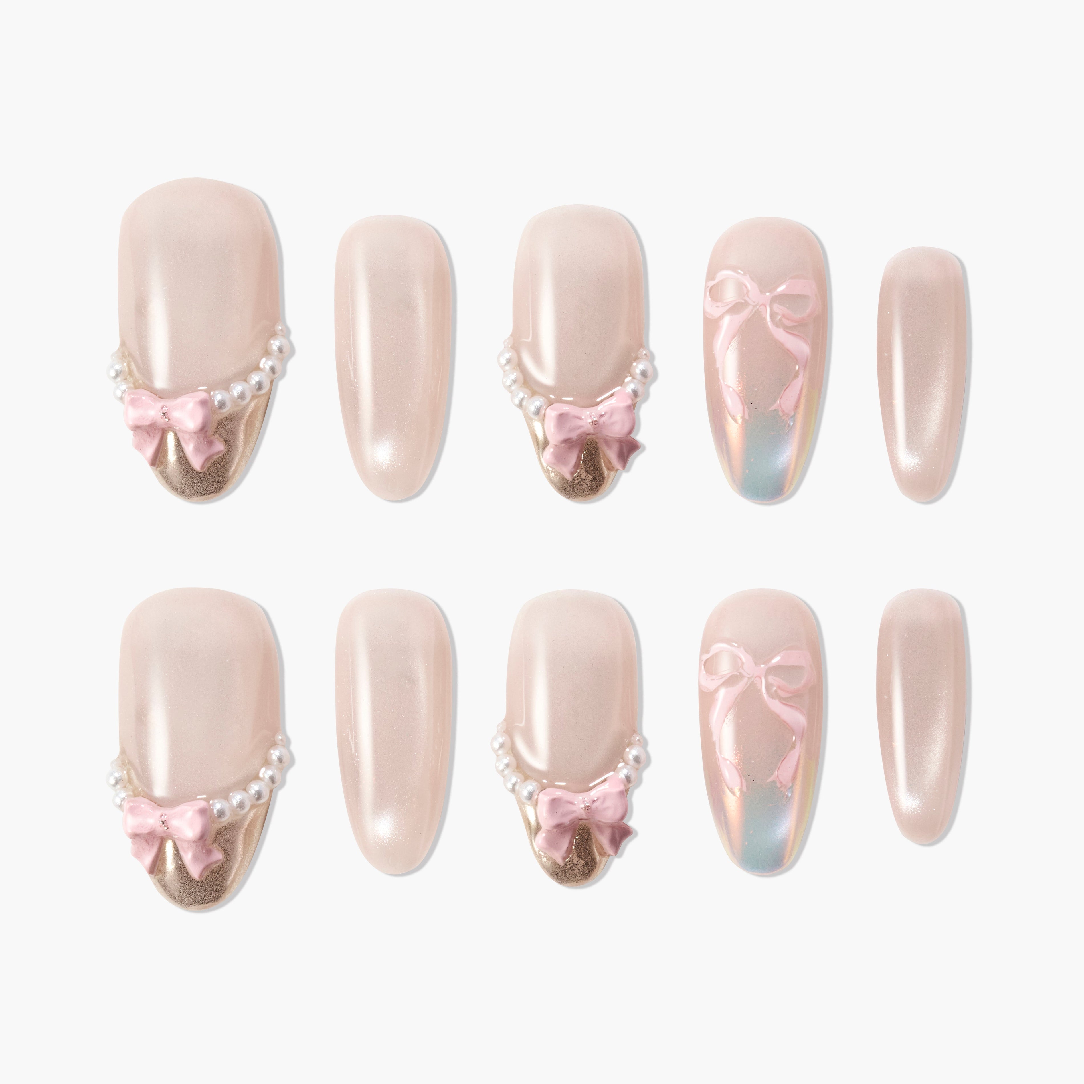 Handmade press-on nails with nude polish, pearl accents, pink bows, and gold tips