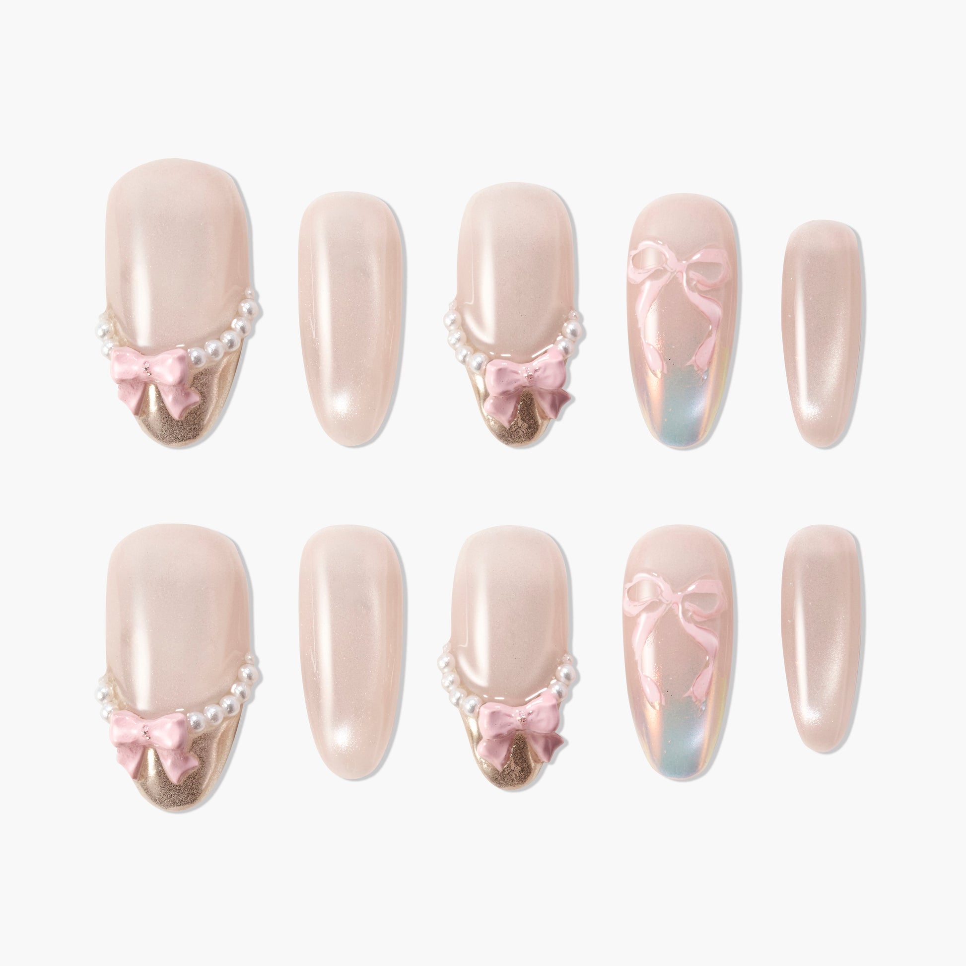 Handmade press-on nails with nude polish, pearl accents, pink bows, and gold tips