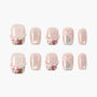 Handmade pink press-on nails with pearl accents, gold tips, and 3D pink bow designs