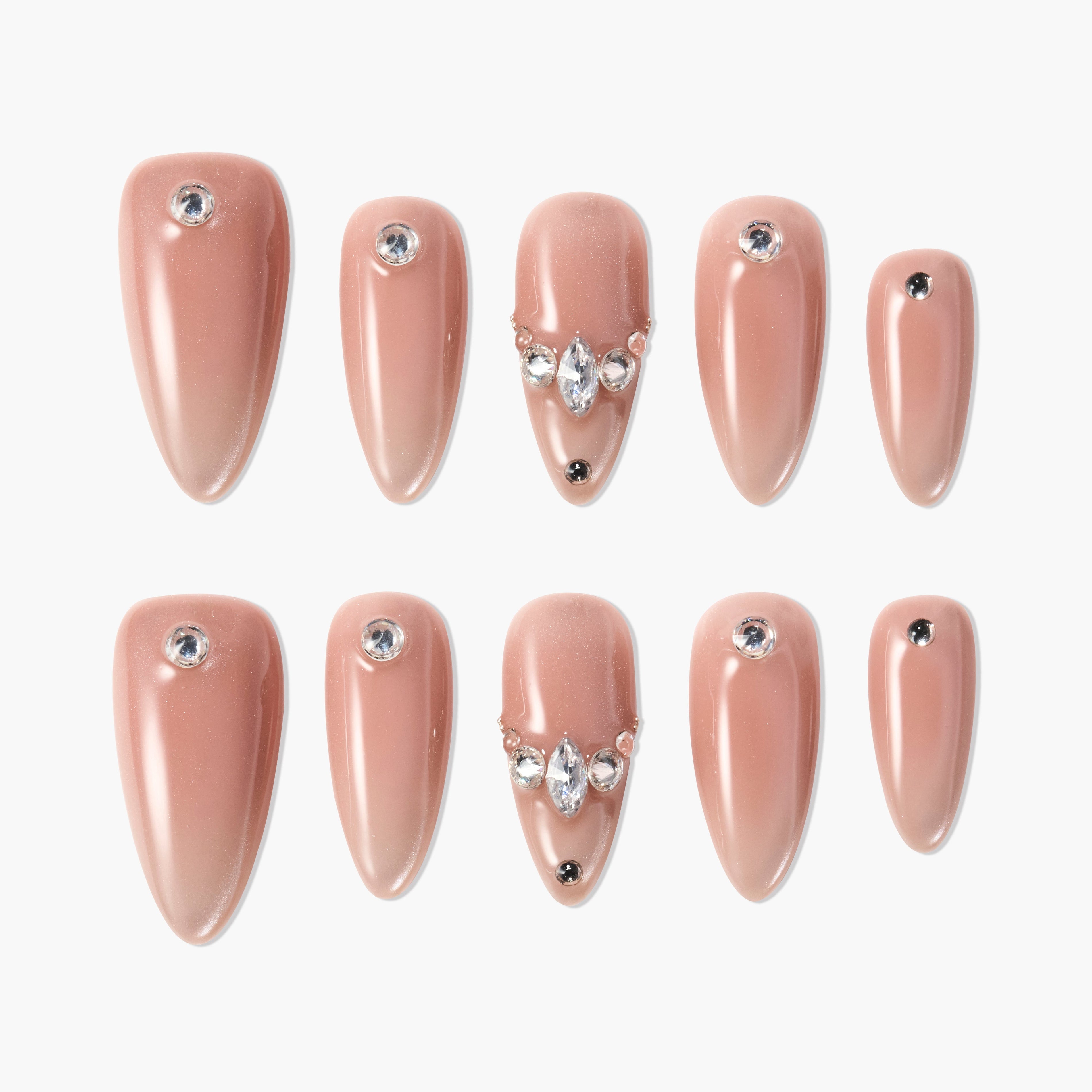 Almond-shaped nude press-on nails with rhinestone and gem accents, elegant nail art set