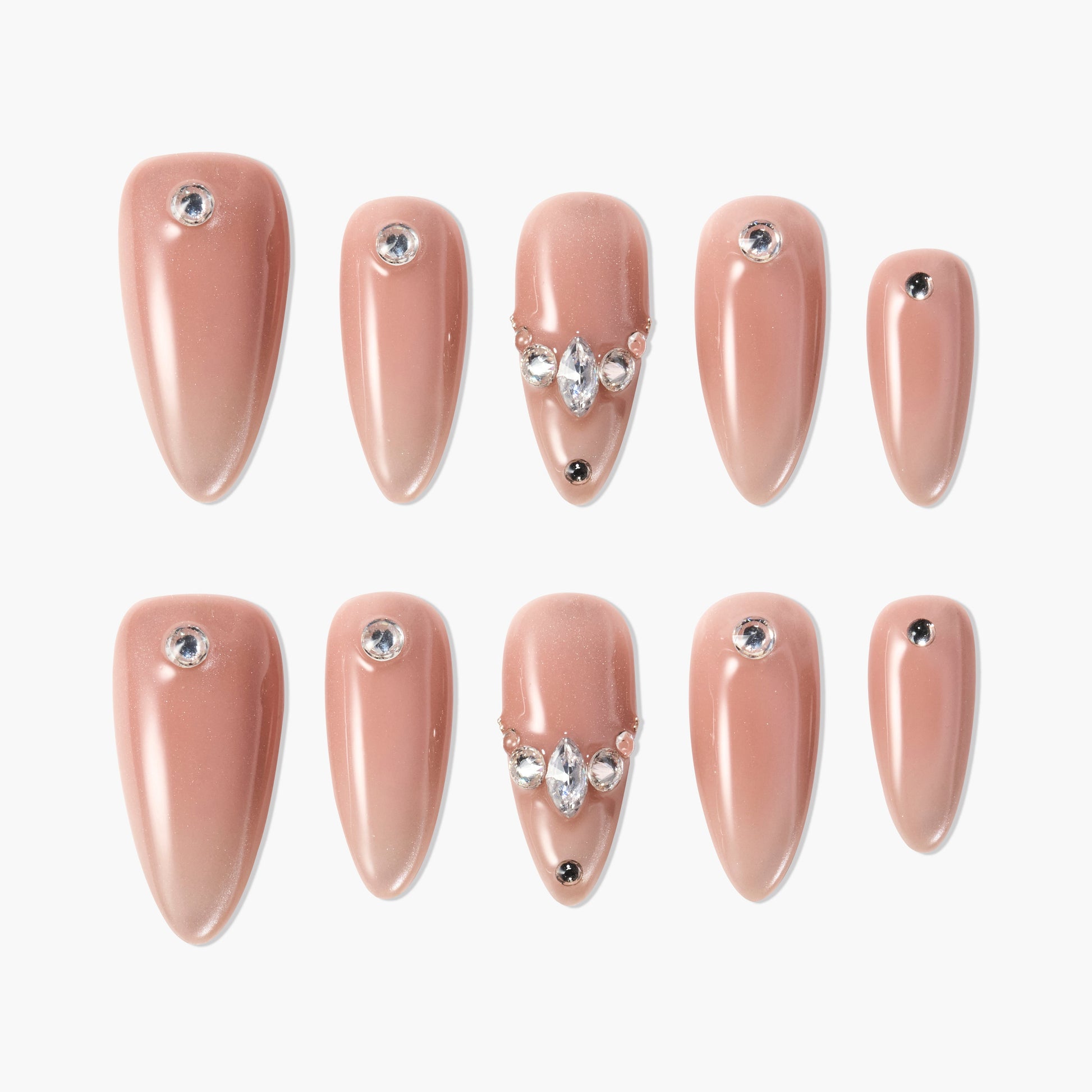 Almond-shaped nude press-on nails with rhinestone and gem accents, elegant nail art set