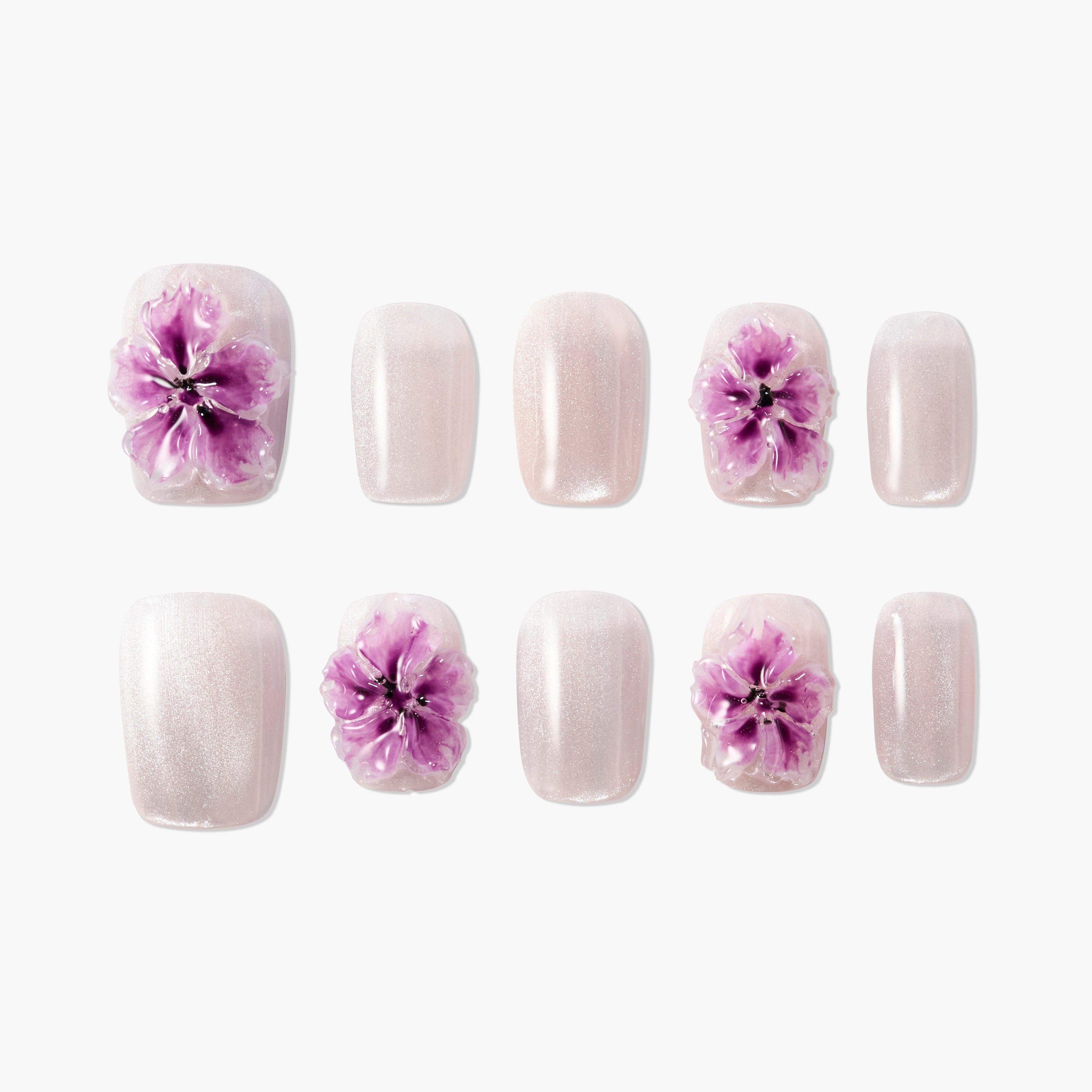 Handmade press-on nails with shimmery pink base and 3D purple flower accents, arranged on white background