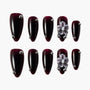Dark burgundy press-on nails with silver studs and 3D white floral accents, glossy finish