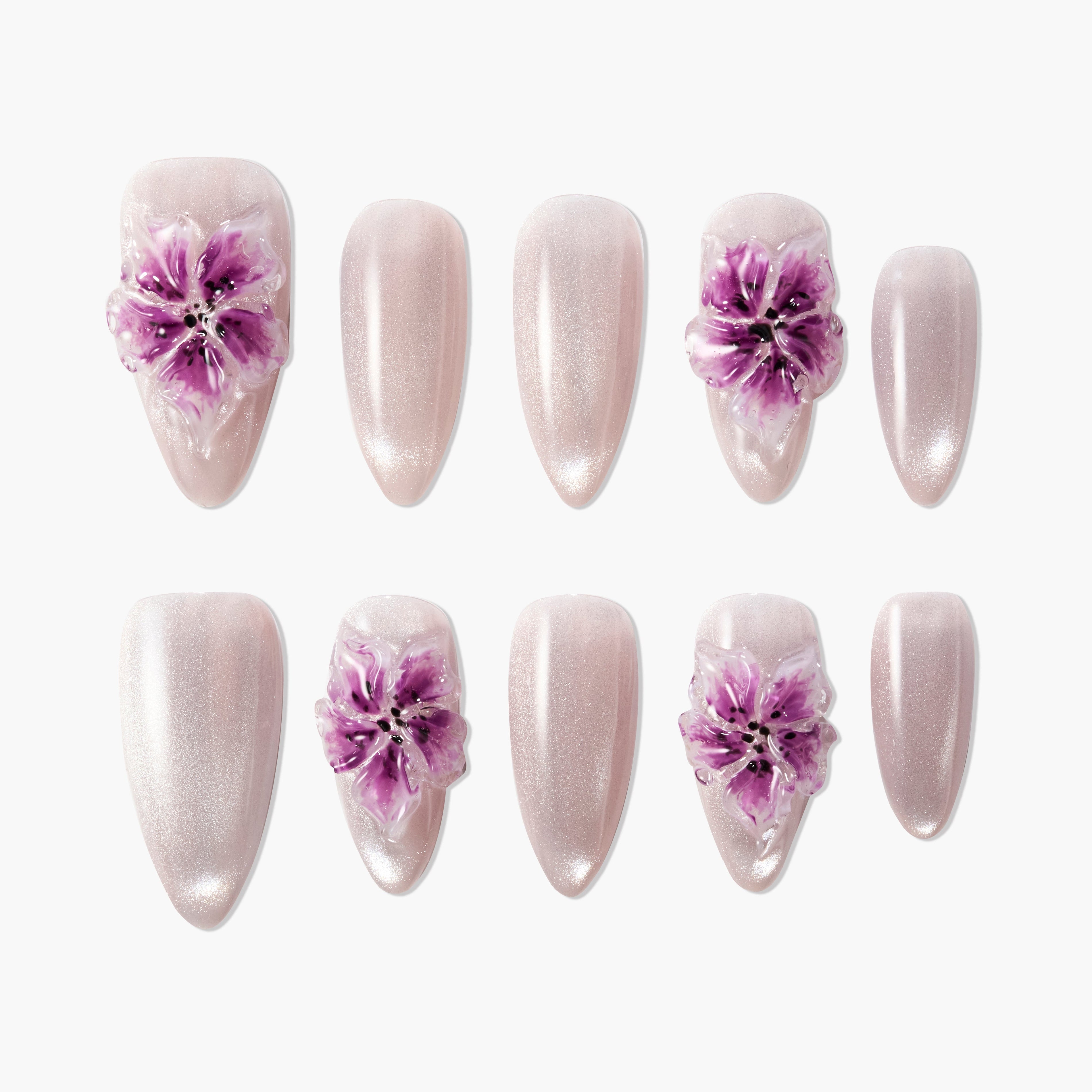 Handmade press-on nails with shimmery nude base and 3D purple floral designs