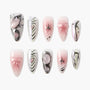 Handmade pink and silver press-on nails with hearts, bows, rhinestones, and abstract designs