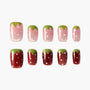 Strawberry-inspired handmade press-on nails with green tips, pink and red bases, and white dots.