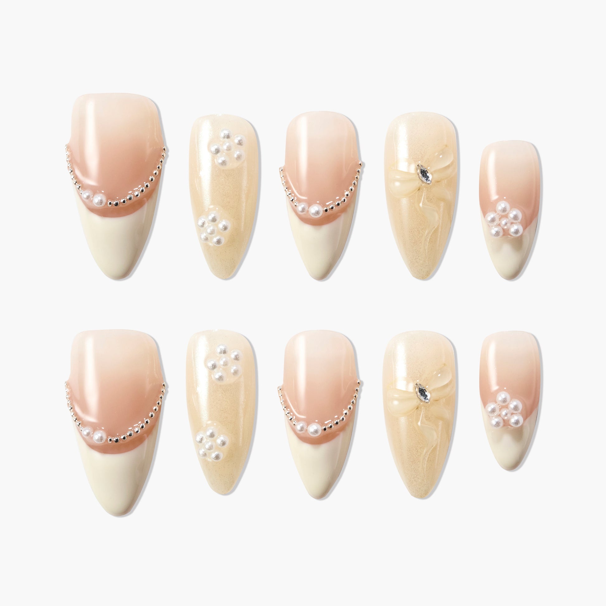 Handmade press-on nails with pearl, rhinestone, and gold glitter designs in nude tones