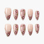 Handmade press-on nails with pink floral design, pearl accents, and nude base, arranged in a set.
