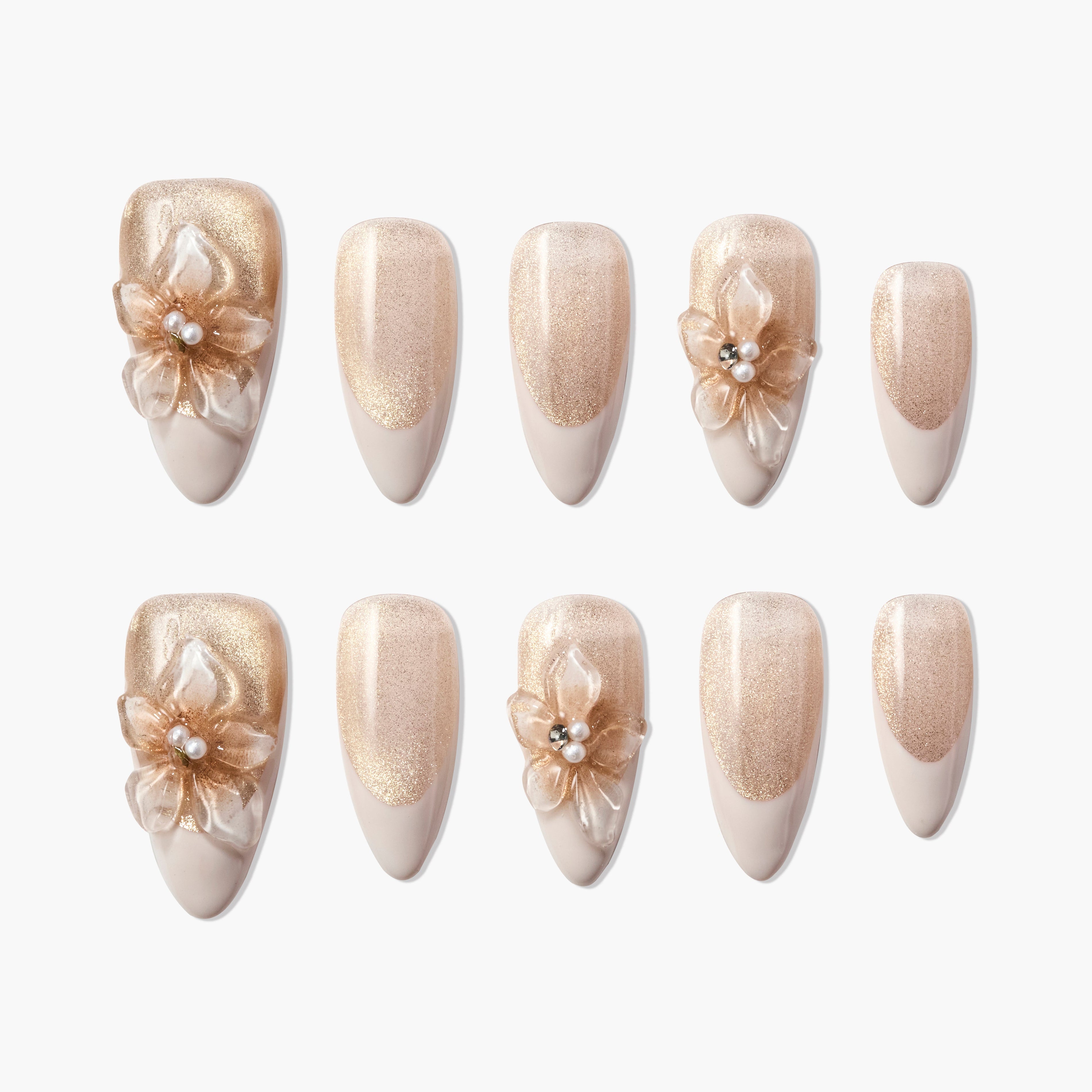 Set of gold and nude press-on nails with 3D floral designs and pearl accents, salon-style finish