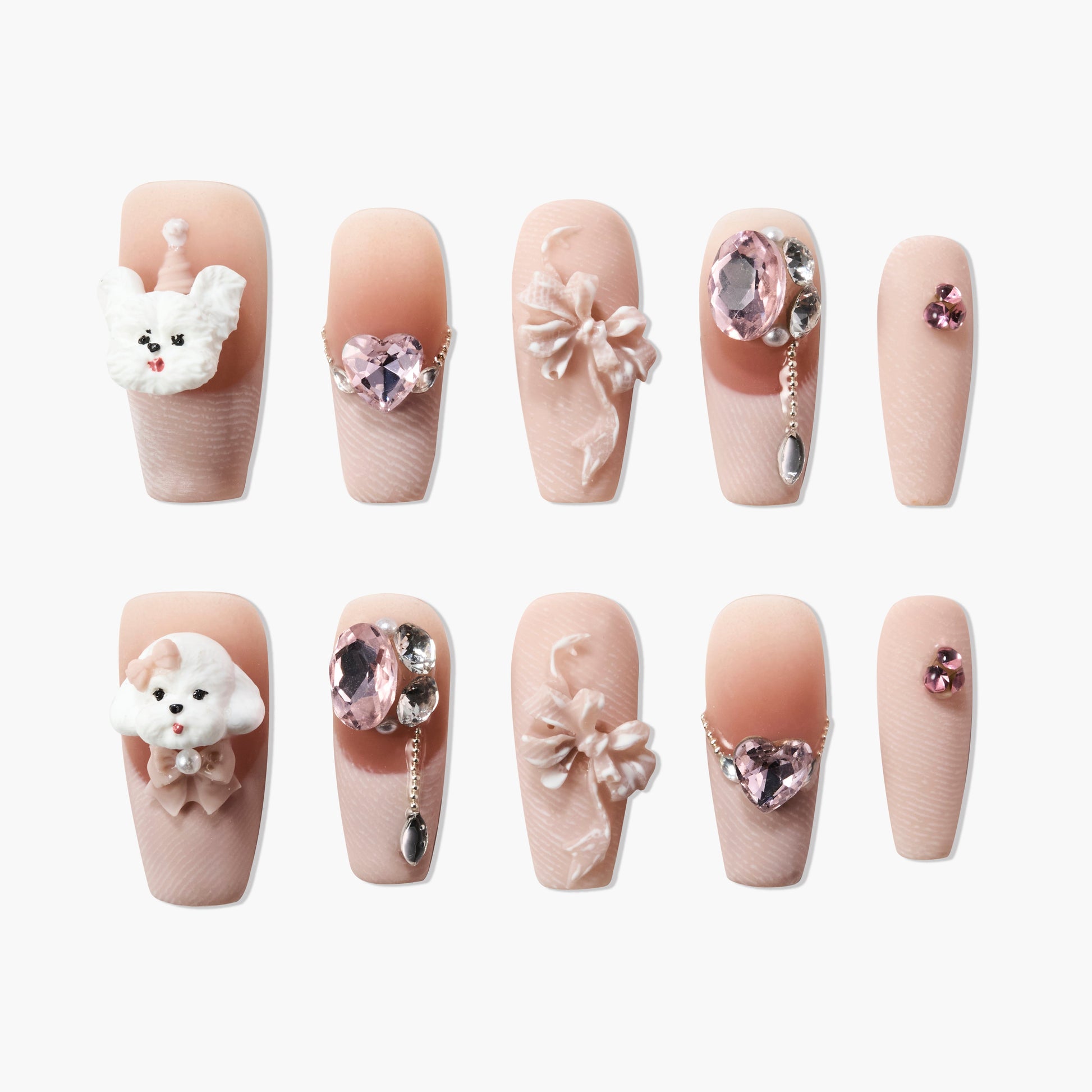 Handmade press-on nails with pink gemstones, 3D bows, and cute poodle dog designs