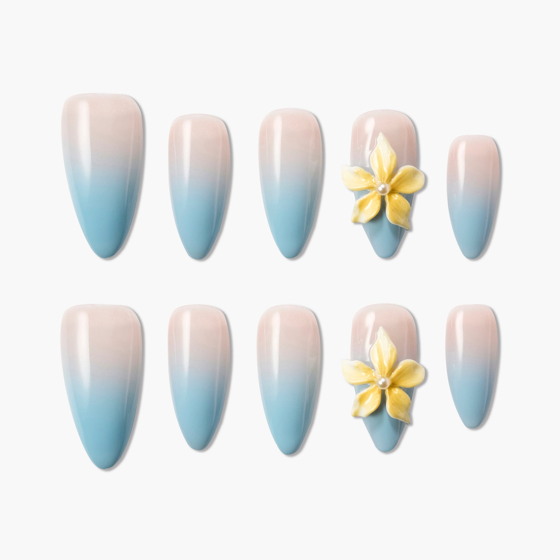 Blue and nude ombre press-on nails with 3D yellow flower accents, displayed on white background.