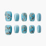 Blue press-on nails with glitter, gold branch designs, and bird accents on white background